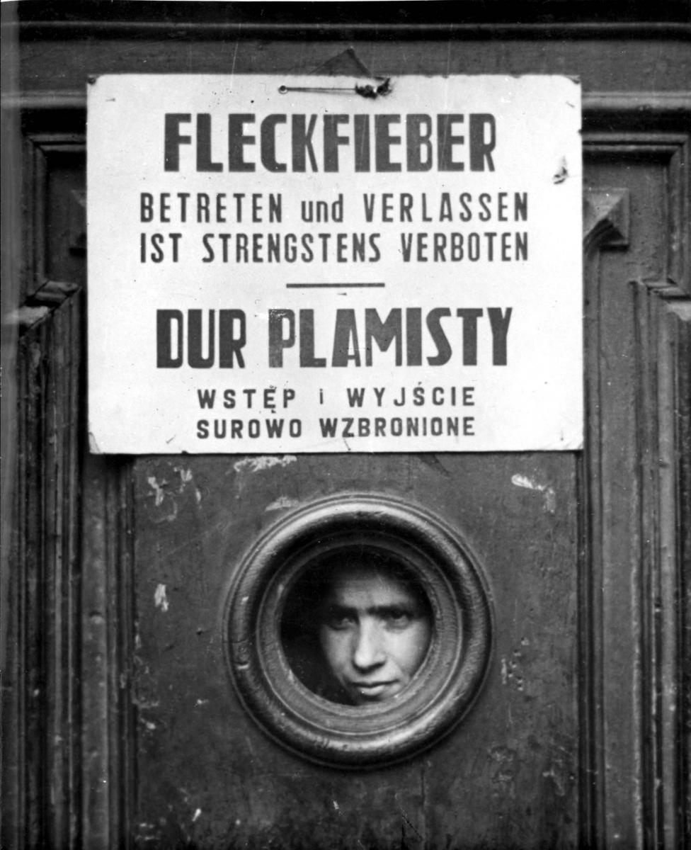 A sign in German and Polish on a building in the ghetto prohibiting entry and exit due to an epidemic.